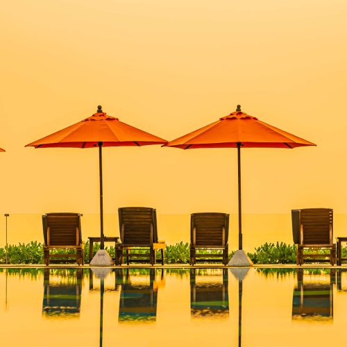 beautiful sunrise around with umbrella chair outdoor swimming pool